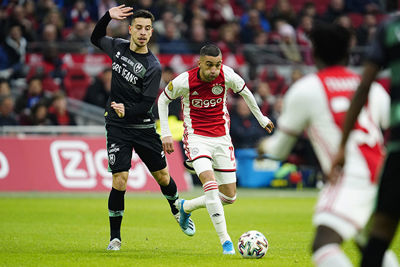 AMSTERDAM, JohanCruyff Arena, 22-12-2019, Dutch football Eredivisie season 2019-2020. ADO Den Haag player Thom Haye and Ajax player Hakim Ziyech during the game Ajax - ADO Den Haag.