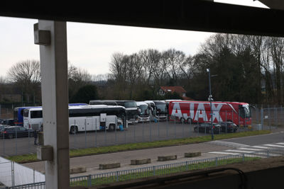 De spelersbus parkeert netjes bij de supportersbussen. © De Brouwer