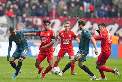 ENSCHEDE, 01-12-2019 , Stadium Grolsch Veste, season 2019 / 2020 . Dutch Eredivisie Football. Ajax players Hakim Ziyech and Daley Blind with FC Twente player Godfried Roemeratoe during the game FC Twente - Ajax 2-5.