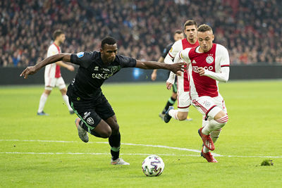 AMSTERDAM, 22-12-2019 JohanCruyff Arena , Dutch Eredivisie Football season 2019 / 2020 . ADO Den Haag player Dion Malone and Ajax player Noa Lang   during the match Ajax - ADO Den Haag