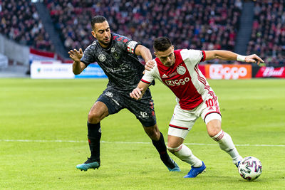 AMSTERDAM, 19-01-2020, football, Johan Cruijff ArenA, Dutch eredivisie, season 2019-2020, Sparta player Adil Aussar (L), Ajax player Dusan Tadic (R), during the match Ajax - Sparta,