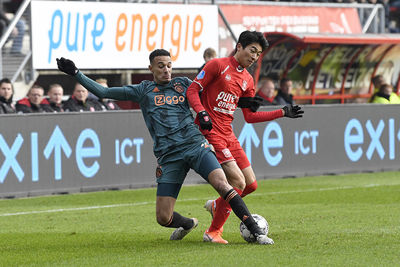 ENSCHEDE, 01-12-2019 , Grolsch Veste , Dutch Eredivisie Football season 2019 / 2020 , Ajax player Noussair Mazraoui and FC Twente player Keito Nakamura during the match FC Twente - Ajax.